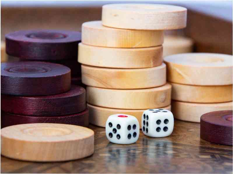 backgammon pieces and dice on a backgammon board